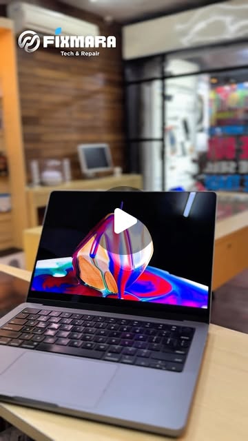 MacBook Pro with its display on at the Fixmara counter, from our screen replacement Reel
