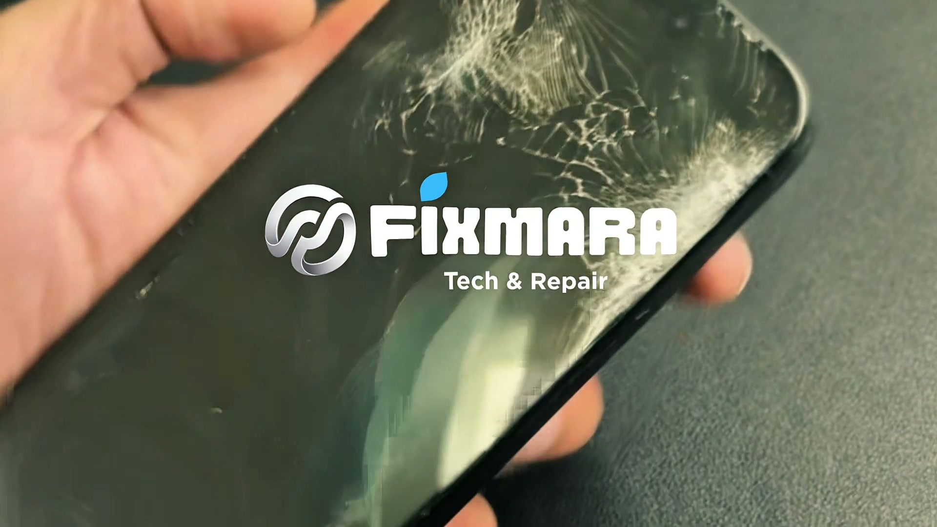 Fixmara repair film showing a damaged phone on the workbench