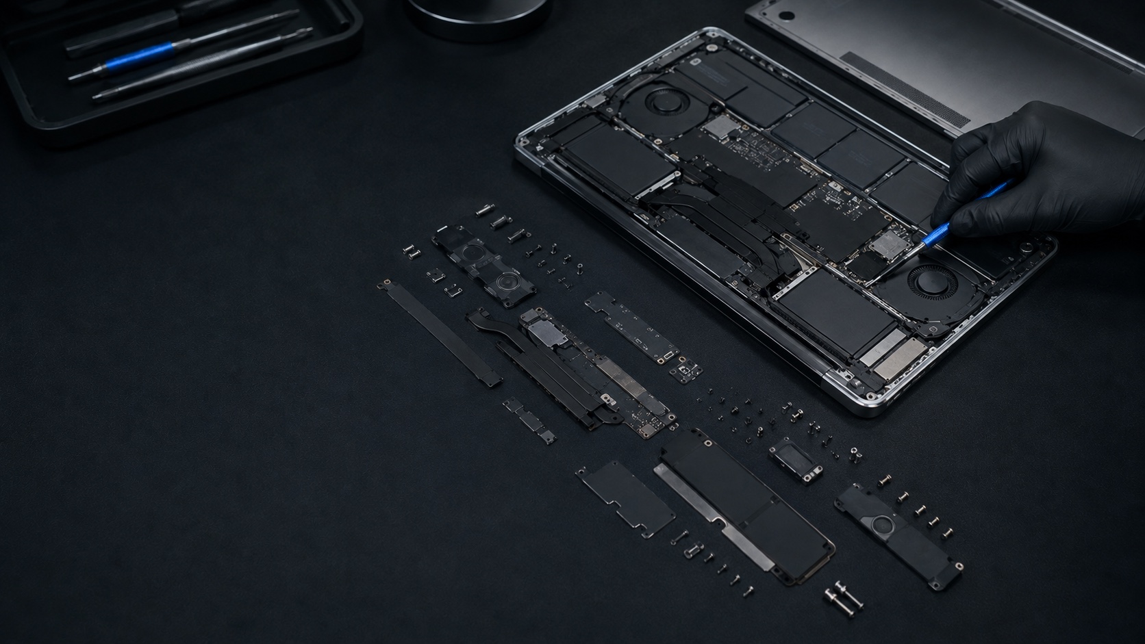 A thin aluminium laptop opened for a meticulous internal teardown