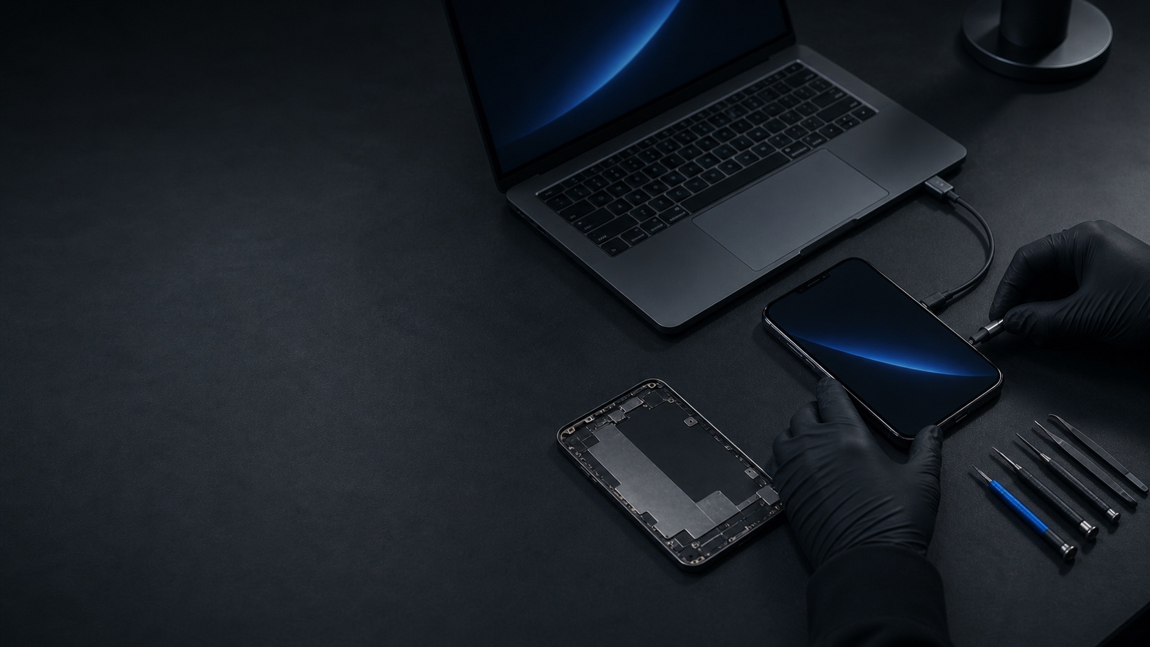 A repaired phone and laptop undergoing final diagnostic testing